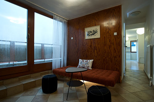 This wood-decorated hallway is framed with a wall to wall window which serves as a door to the 40 square meter terrace. Large families can use this day bed as a regular single bed, if needed.