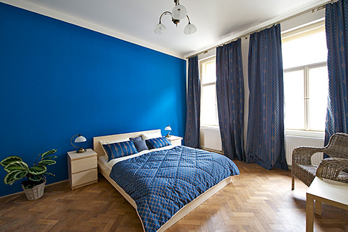 Main bedroom is a large square room with a king size double bed and original wooden parquet floors. It has one entrance from the kitchen and another double door connects this room with the living room. Double windows insulate from cold or heat as well as street noise.