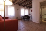KITCHEN WITH SOFA AND TOILET ON THE RIGHT
