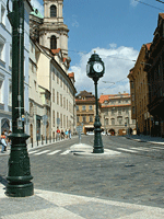 A clock tower rises up from Ujezd street
